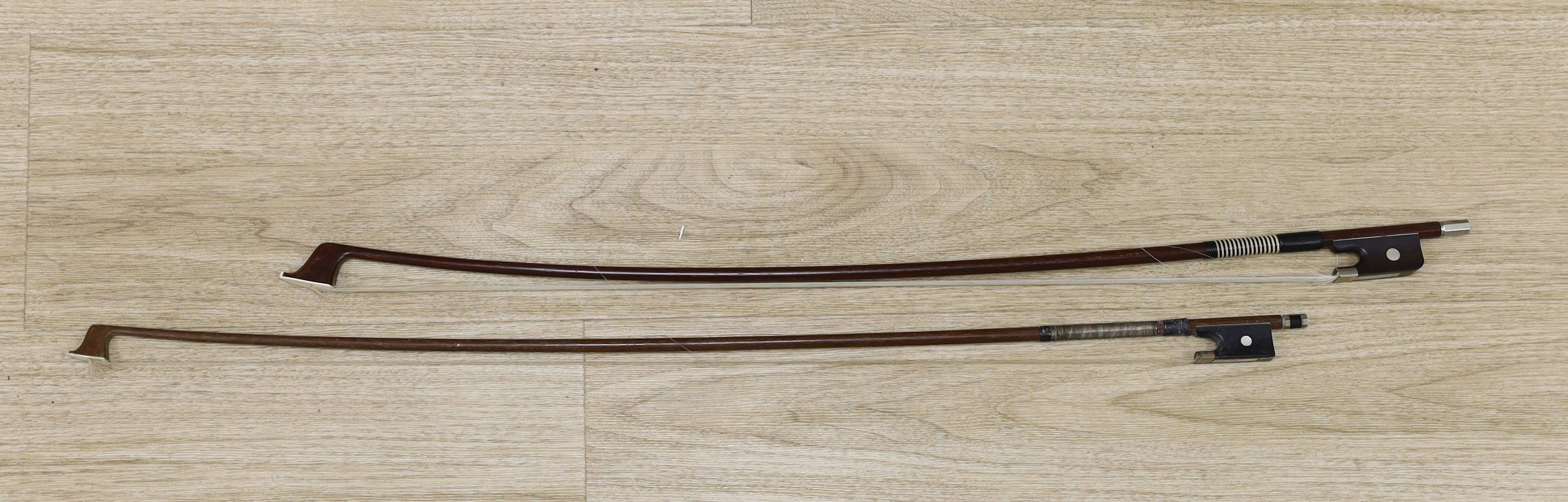 Two violin bows, signed Erich Steiner and Tourte, 73 cms long.